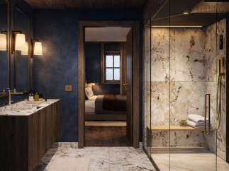 Experience luxury in this master bathroom featuring a spacious walk-in shower with marble tile and a built-in bench.