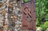 Discover the charm of Castle Rock with this stunning property! This home boasts a beautiful stone facade and a welcoming entrance sign.