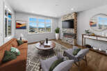 Step into luxury with this stunning living room, boasting a modern fireplace and expansive windows that frame breathtaking mountain views.