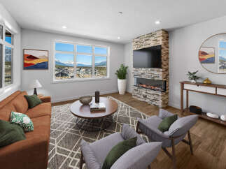 Step into luxury with this stunning living room, boasting a modern fireplace and expansive windows that frame breathtaking mountain views.