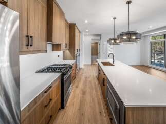 This stunning kitchen boasts modern design with sleek cabinetry and a spacious island, perfect for culinary enthusiasts.