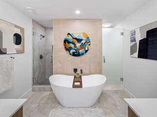 Step into luxury with this stunning bathroom, featuring a modern freestanding tub and a separate glass-enclosed shower.