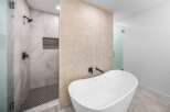 Step into luxury with this stunning bathroom featuring a sleek, modern design.