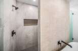 Step into luxury with this stunning bathroom featuring exquisite tile work and modern fixtures.