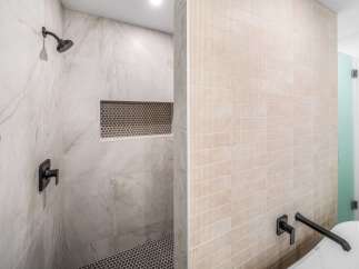Step into luxury with this stunning bathroom featuring exquisite tile work and modern fixtures.