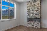 This stunning property boasts a modern fireplace with a stone facade, creating a cozy and inviting atmosphere.