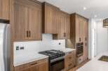 This stunning kitchen boasts custom cabinetry and high-end appliances, perfect for the discerning homeowner.