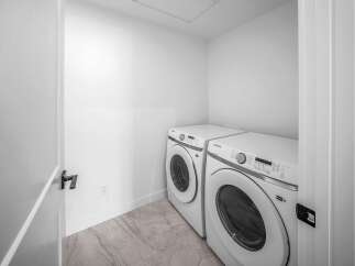 Step into this modern laundry room, featuring a sleek Samsung washer and dryer set.