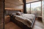 Experience luxury in this stunning bedroom featuring a plush, fur-like blanket and a cozy, inviting atmosphere.
