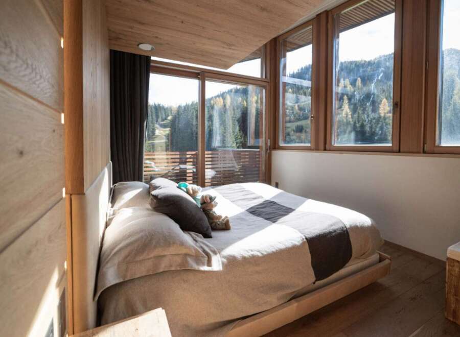 Experience the tranquility of this stunning bedroom with breathtaking mountain views.