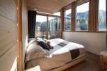 Experience the tranquility of this stunning bedroom with breathtaking mountain views.