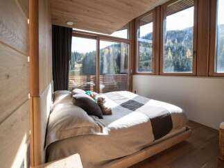 Experience the tranquility of this stunning bedroom with breathtaking mountain views.