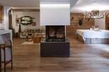 Experience rustic elegance in this stunning property, featuring a modern fireplace as the centerpiece.
