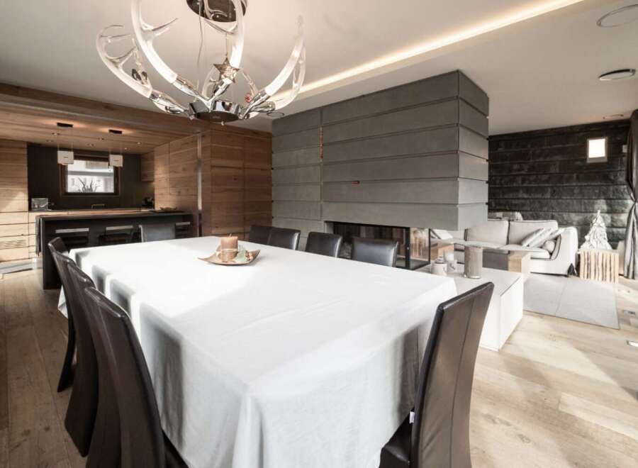 Experience luxury living in this stunning property featuring a modern fireplace, elegant dining area, and a stylish kitchen.
