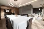 Experience luxury living in this stunning property featuring a modern fireplace, elegant dining area, and a stylish kitchen.