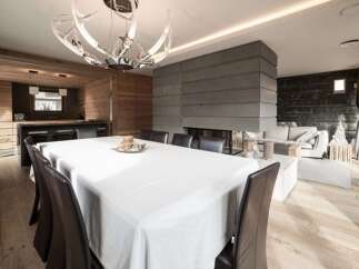 Experience luxury living in this stunning property featuring a modern fireplace, elegant dining area, and a stylish kitchen.