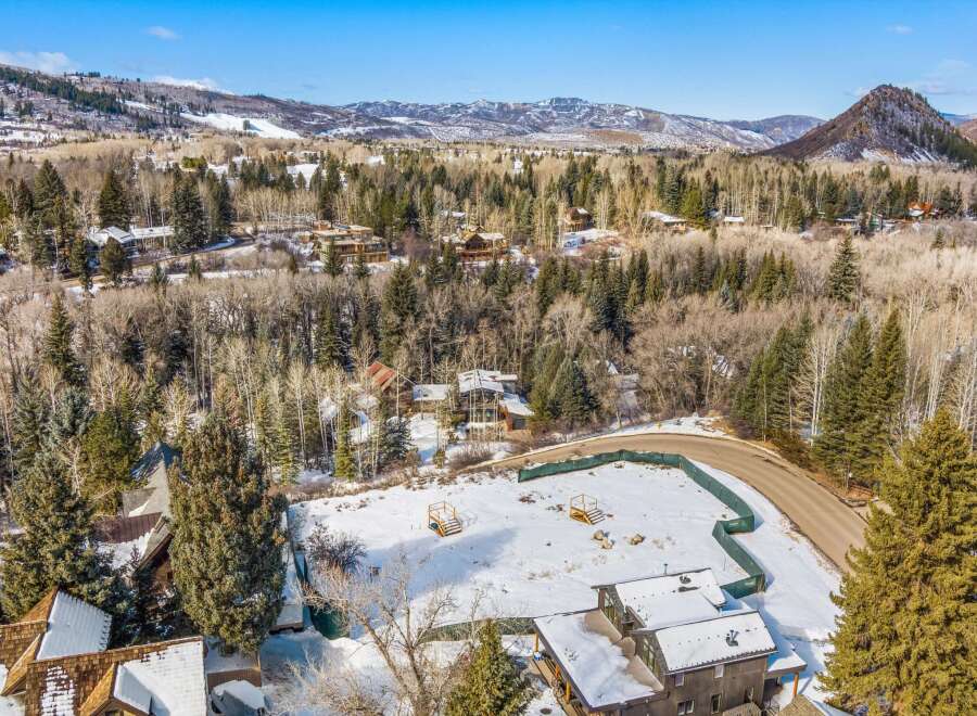 Nestled in a serene mountain landscape, this property offers a blend of natural beauty and modern living.