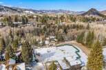 Nestled in a serene mountain landscape, this property offers a blend of natural beauty and modern living.
