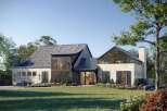 This stunning modern farmhouse boasts a unique architectural design with a blend of textures and styles.