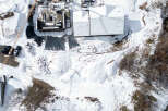 This stunning property boasts a modern design with a snow-covered roof, perfect for winter enthusiasts.