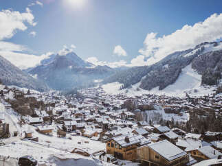 Nestled in a picturesque winter wonderland, this charming property offers stunning views of snow-capped mountains and a quaint village.