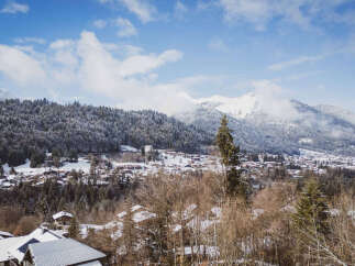 Nestled in a picturesque winter wonderland, this property offers stunning views of snow-capped mountains and a charming village.