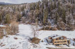 Nestled in a serene winter wonderland, this stunning property offers a luxurious escape.