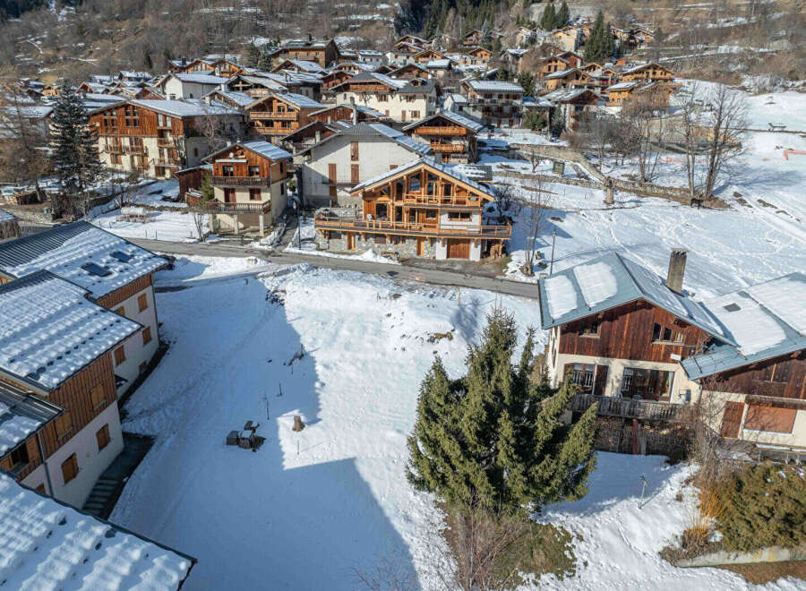Discover the charm of this stunning mountain village nestled in a snowy landscape.