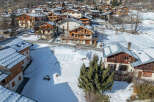 Discover the charm of this stunning mountain village nestled in a snowy landscape.