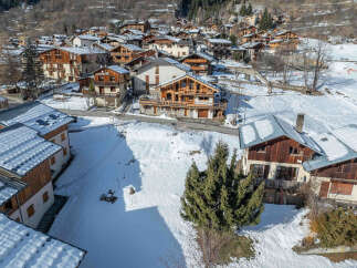 Discover the charm of this stunning mountain village nestled in a snowy landscape.
