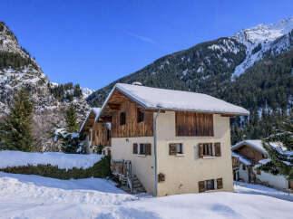 Discover a charming chalet nestled in a picturesque winter wonderland.