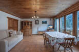 Step into this charming living space, featuring a warm wooden ceiling and inviting ambiance.