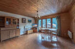 This charming property features a cozy living space with wooden paneling and a warm, inviting atmosphere.