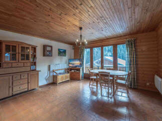 This charming property features a cozy living space with wooden paneling and a warm, inviting atmosphere.