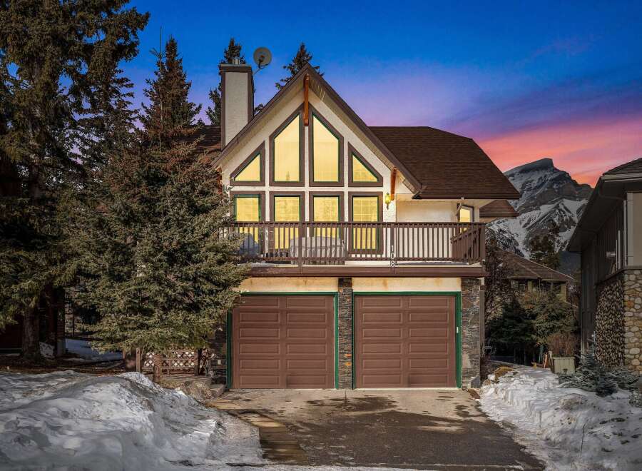 This stunning property boasts a unique architectural design with a charming balcony and a two-car garage.