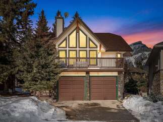 This stunning property boasts a unique architectural design with a charming balcony and a two-car garage.