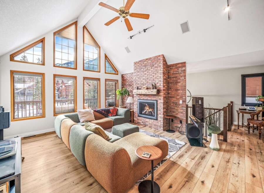 Step into luxury with this stunning property featuring a spacious living area, highlighted by a cozy fireplace and expansive windows that flood the space with natural light.