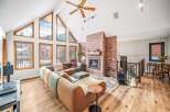 Step into luxury with this stunning property featuring a spacious living area, highlighted by a cozy fireplace and expansive windows that flood the space with natural light.