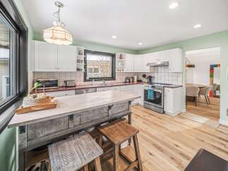 Step into this beautifully designed kitchen, featuring a spacious island perfect for meal prep and entertaining.