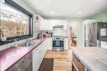 This stunning kitchen boasts a modern design with sleek stainless steel appliances and ample counter space.