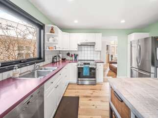 This stunning kitchen boasts a modern design with sleek stainless steel appliances and ample counter space.