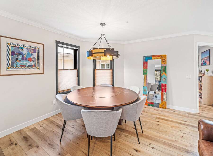 This stunning dining room features a modern round table with seating for six, perfect for hosting dinner parties.