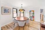 This stunning dining room features a modern round table with seating for six, perfect for hosting dinner parties.