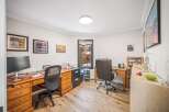 This inviting home office offers a blend of functionality and style, perfect for remote work or creative pursuits.