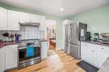 Step into this stunning kitchen, featuring sleek stainless steel appliances and ample counter space.