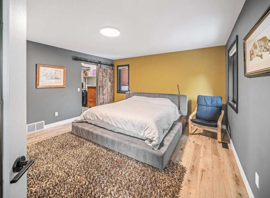 This stunning bedroom boasts a modern design with a cozy, inviting atmosphere.