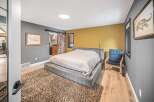 This stunning bedroom boasts a modern design with a cozy, inviting atmosphere.