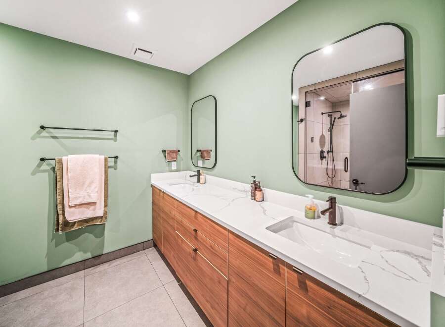 Step into luxury with this stunning bathroom! Featuring a sleek, modern design, this space boasts a beautiful vanity with ample storage and a pristine countertop.