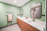 Step into luxury with this stunning bathroom! Featuring a sleek, modern design, this space boasts a beautiful vanity with ample storage and a pristine countertop.