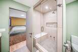 Step into luxury with this stunning bathroom featuring a modern glass-enclosed shower and elegant tile work.